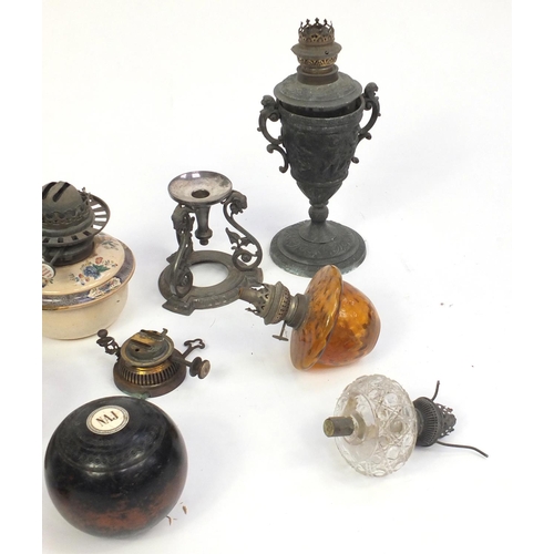 267 - Oil lamps and reservoirs including painted porcelain and glass examples