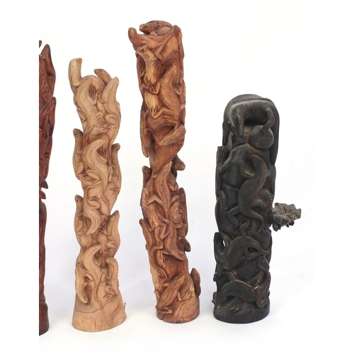 459 - Five carved wood lizard groups, the largest 68cm high