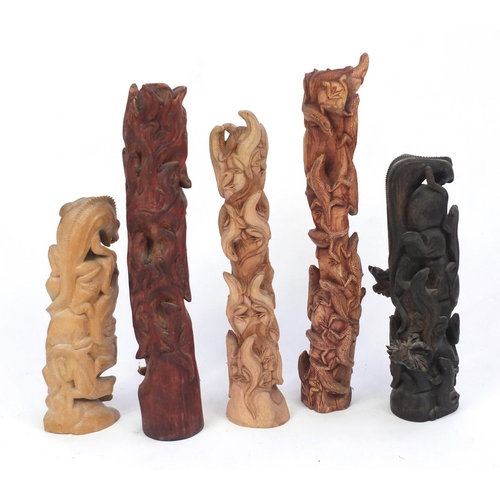 459 - Five carved wood lizard groups, the largest 68cm high