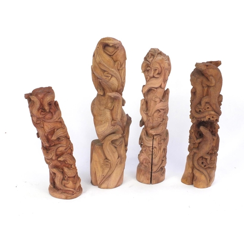 119 - Four carved wood lizard groups, the largest 76cm high