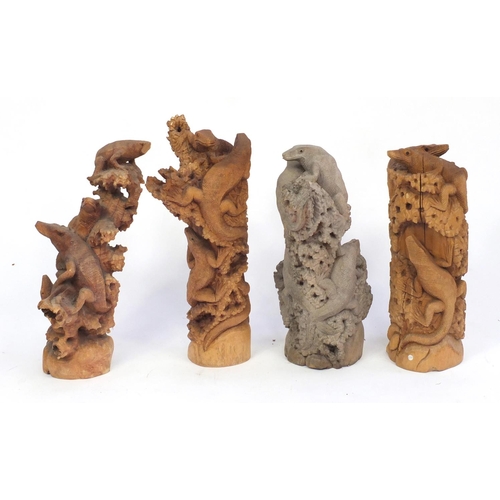 165 - Four carved wood lizard groups, the largest 60cm high