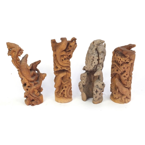 165 - Four carved wood lizard groups, the largest 60cm high