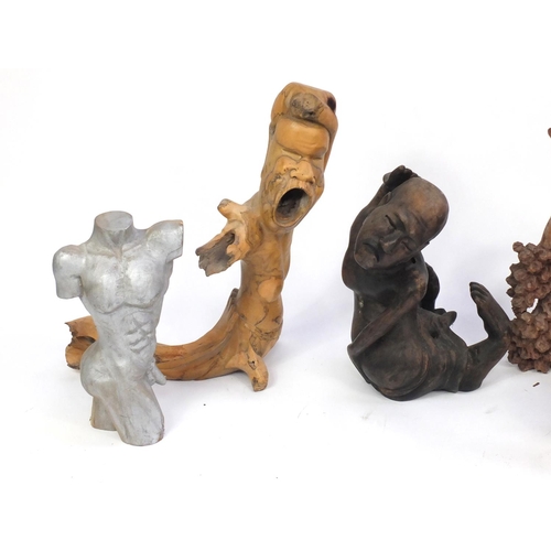 624 - Wooden carvings including surreal figures and dolphins, the largest 73cm high