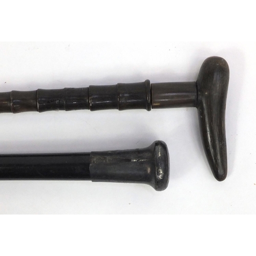 246 - Ebonised walking cane with silver handle, a horn walking cane and two violin bows