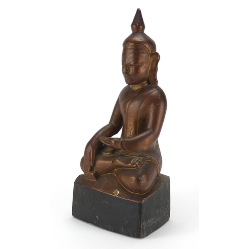 397 - Gilt and black painted carved wooden figure of Buddha, 39cm high