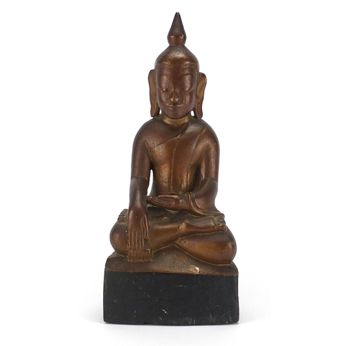 397 - Gilt and black painted carved wooden figure of Buddha, 39cm high