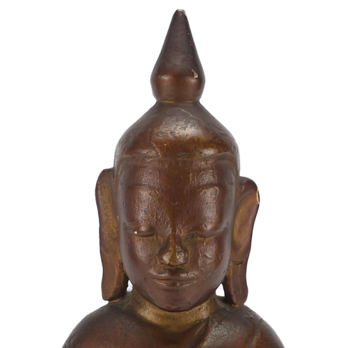 397 - Gilt and black painted carved wooden figure of Buddha, 39cm high