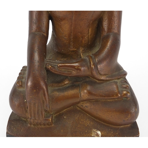 397 - Gilt and black painted carved wooden figure of Buddha, 39cm high