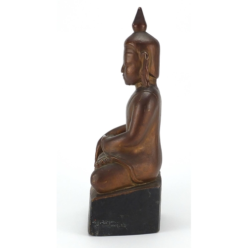 397 - Gilt and black painted carved wooden figure of Buddha, 39cm high