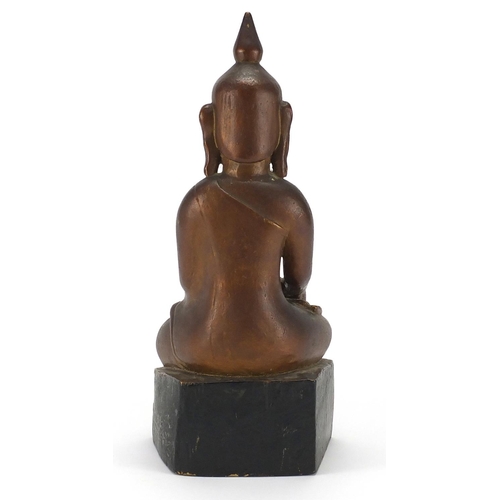 397 - Gilt and black painted carved wooden figure of Buddha, 39cm high