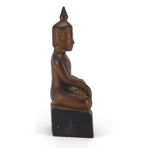 397 - Gilt and black painted carved wooden figure of Buddha, 39cm high