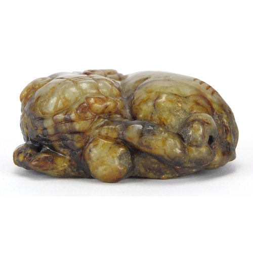 422 - Chinese russet and green jade carving of a Buddhistic lion, 6cm wide