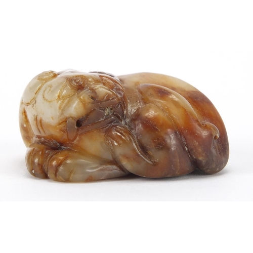 423 - Chinese russet and white jade carving of a mythical lion, 6cm wide