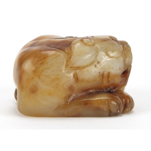 423 - Chinese russet and white jade carving of a mythical lion, 6cm wide