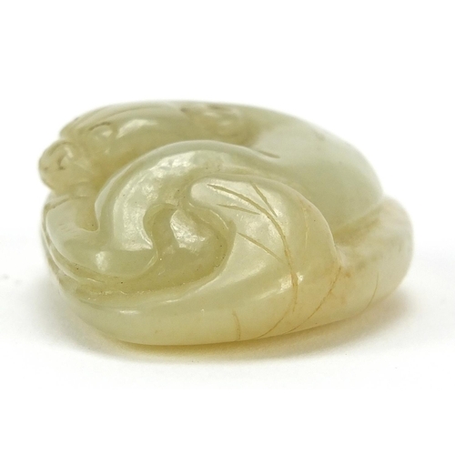 428 - Chinese green jade carving of a mythical recumbent cat upon a lily pad, 4.5cm wide