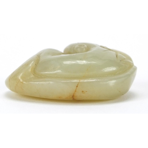 428 - Chinese green jade carving of a mythical recumbent cat upon a lily pad, 4.5cm wide