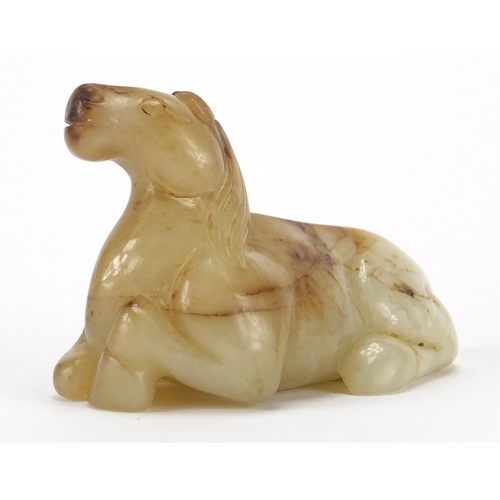 417 - Chinese white and russet jade carving of a recumbent horse, 8cm in length