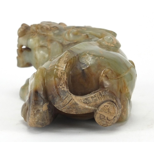 420 - Large Chinese green and russet jade carving of a crouching mythical lion, 13cm wide