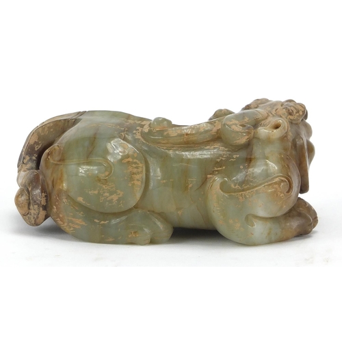 420 - Large Chinese green and russet jade carving of a crouching mythical lion, 13cm wide