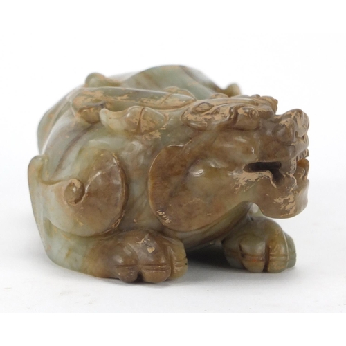 420 - Large Chinese green and russet jade carving of a crouching mythical lion, 13cm wide