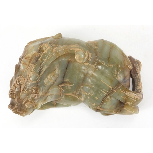 420 - Large Chinese green and russet jade carving of a crouching mythical lion, 13cm wide