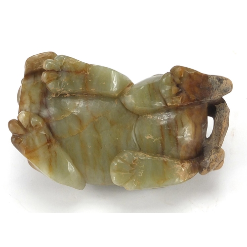 420 - Large Chinese green and russet jade carving of a crouching mythical lion, 13cm wide