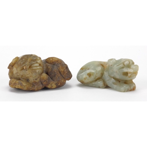 426 - Two Chinese green and russet jade carvings of recumbent lions, the largest 5.5cm wide