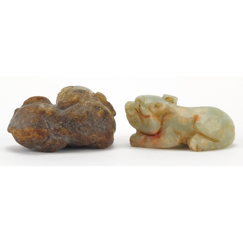 426 - Two Chinese green and russet jade carvings of recumbent lions, the largest 5.5cm wide