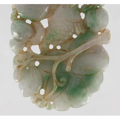 430 - Chinese white and green jade pendant, carved and pierced with a fish and fruit, 9.5cm high