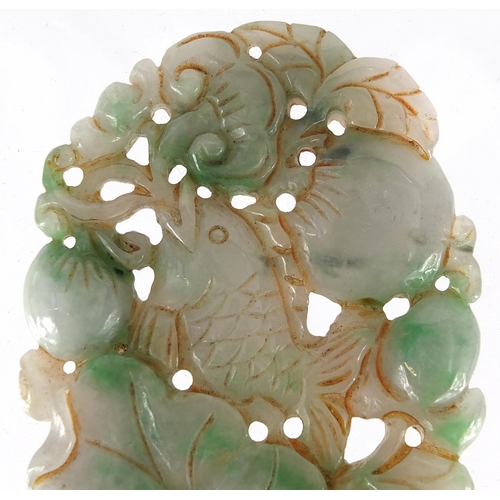 430 - Chinese white and green jade pendant, carved and pierced with a fish and fruit, 9.5cm high