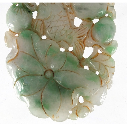 430 - Chinese white and green jade pendant, carved and pierced with a fish and fruit, 9.5cm high