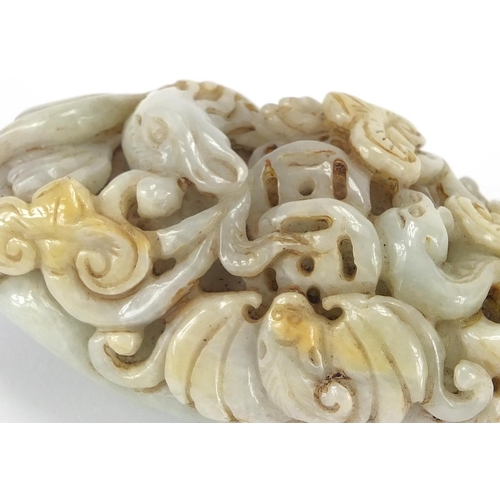 429 - Chinese white jade touch stone carved with a bird of Paradise and a bat, 8.5cm high