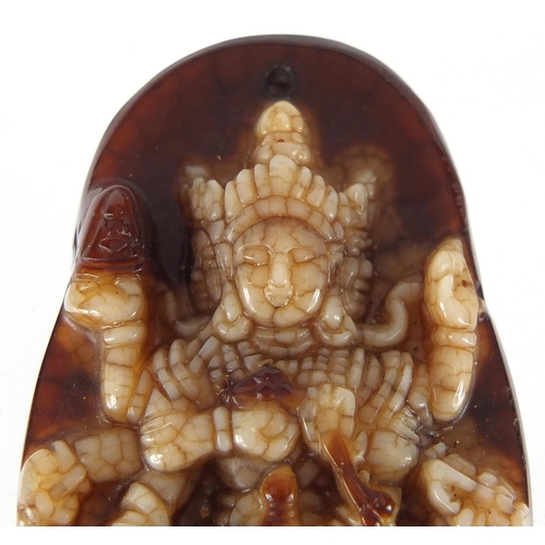 432 - Tibetan brown and white jade pendant carved with a Goddess, 4.5cm high