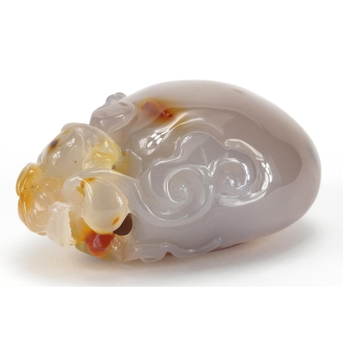 435 - Chinese pale agate touch stone, carved with a dragon, 10cm high