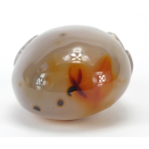 435 - Chinese pale agate touch stone, carved with a dragon, 10cm high