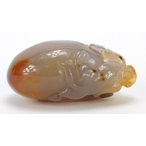 435 - Chinese pale agate touch stone, carved with a dragon, 10cm high