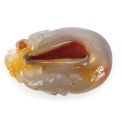 435 - Chinese pale agate touch stone, carved with a dragon, 10cm high