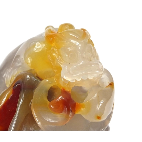 435 - Chinese pale agate touch stone, carved with a dragon, 10cm high