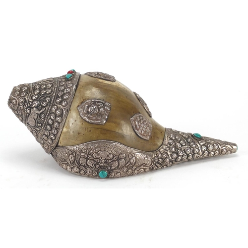 467 - Tibetan silver mounted Conch shell set with coral and turquoise stones, the silver mounts embossed w... 