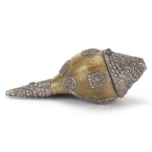 467 - Tibetan silver mounted Conch shell set with coral and turquoise stones, the silver mounts embossed w... 