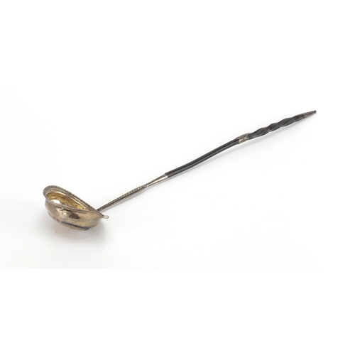 672 - Unmarked Georgian silver ladle with twisted horn handle, 40cm in length