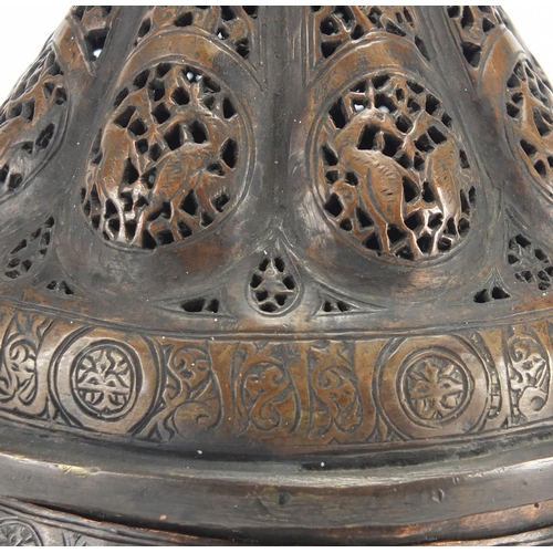 472 - Islamic bronze incense burner with open metal work, embossed with wild animals, 24cm high