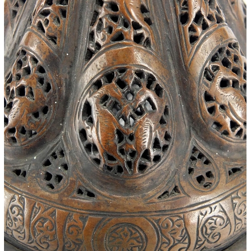 472 - Islamic bronze incense burner with open metal work, embossed with wild animals, 24cm high