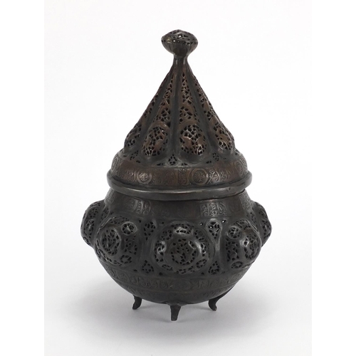 472 - Islamic bronze incense burner with open metal work, embossed with wild animals, 24cm high