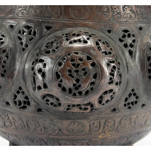 472 - Islamic bronze incense burner with open metal work, embossed with wild animals, 24cm high