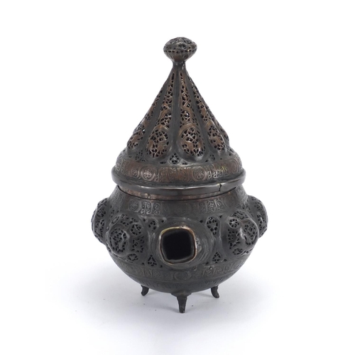 472 - Islamic bronze incense burner with open metal work, embossed with wild animals, 24cm high