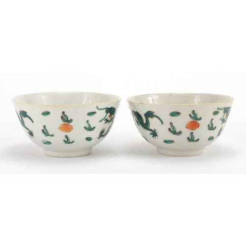 348 - Pair of Chinese porcelain bowls, both hand painted in the famille verte palette with dragons amongst... 