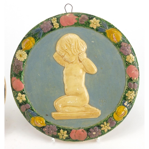 541 - Circular stoneware wall plaque hand painted with Madonna and Child together with a plaster example, ... 