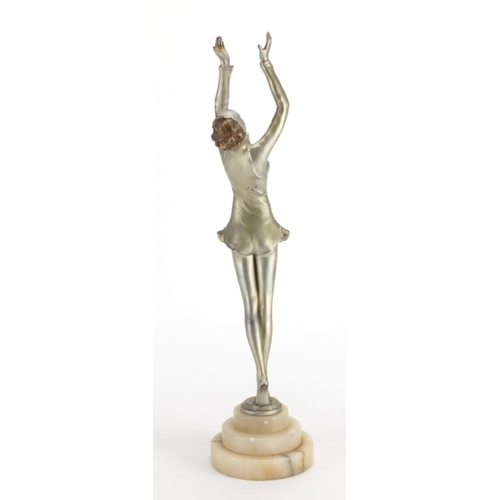 598 - Art Deco silvered metal study of a performer, raised on a circular stepped onyx base, 39cm high