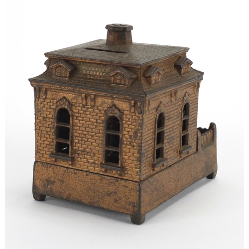 327 - Novelty cast iron money box in the form of a dog rotating in and out of a house, 14cm in length